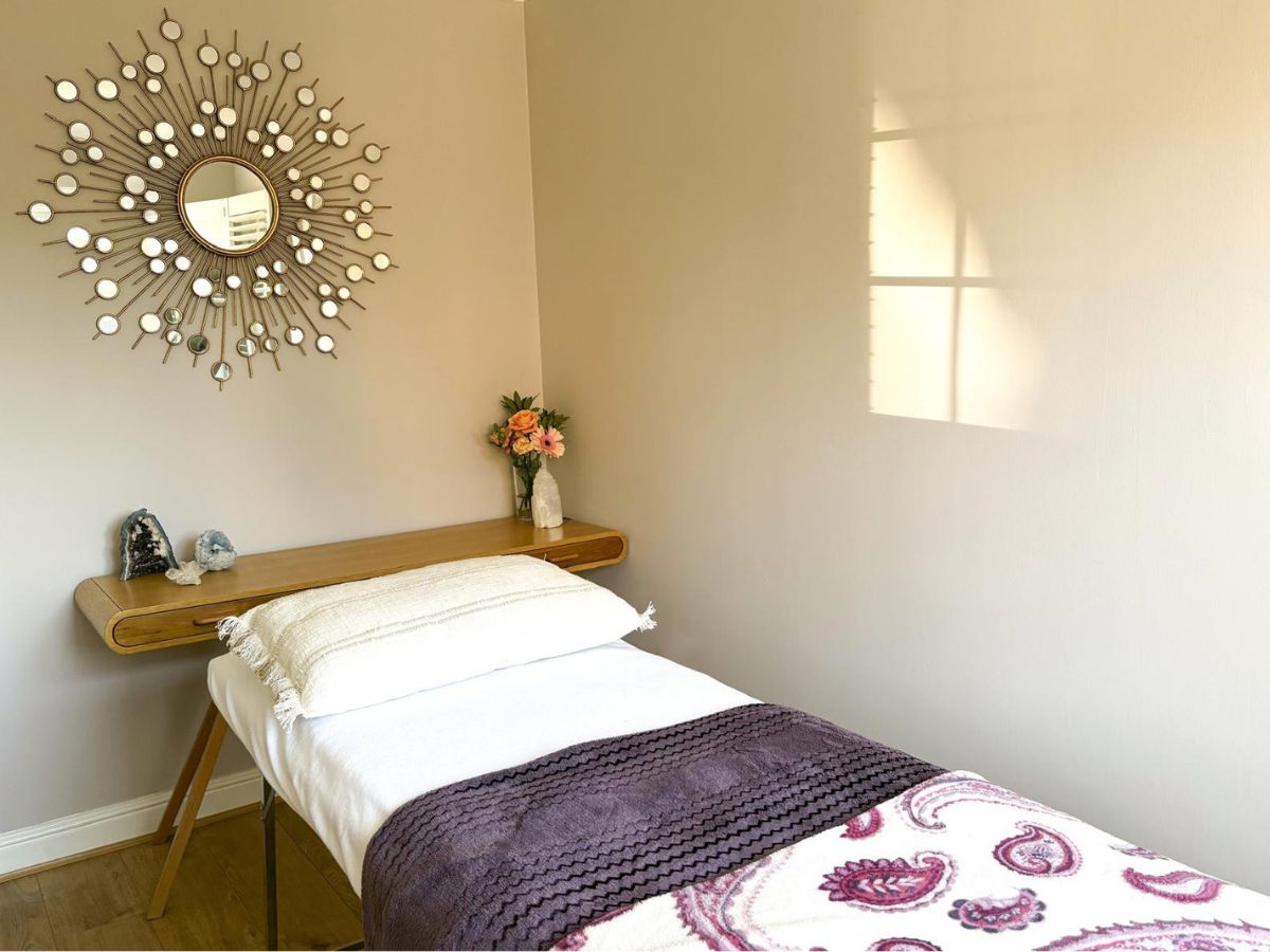 Sunshine Holistics calming treatment room in Hertford with therapy couch and sunshine mirror